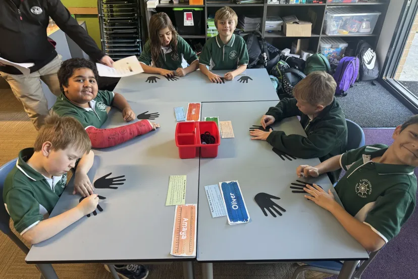 Students working together on an activity around joined desks