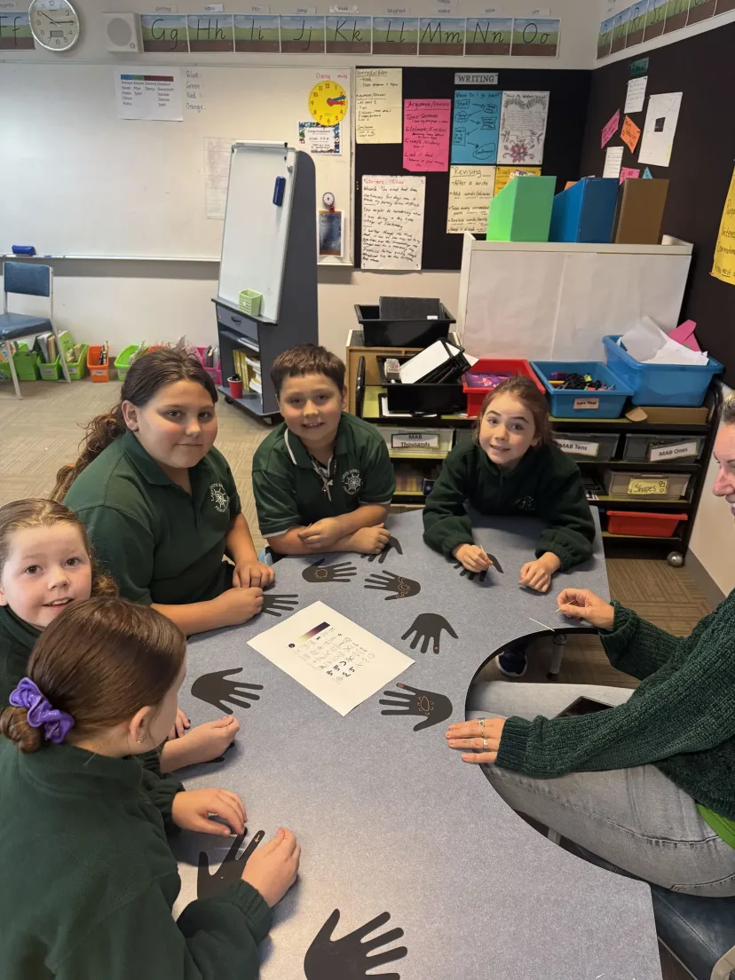 A class working in a group around a shared table