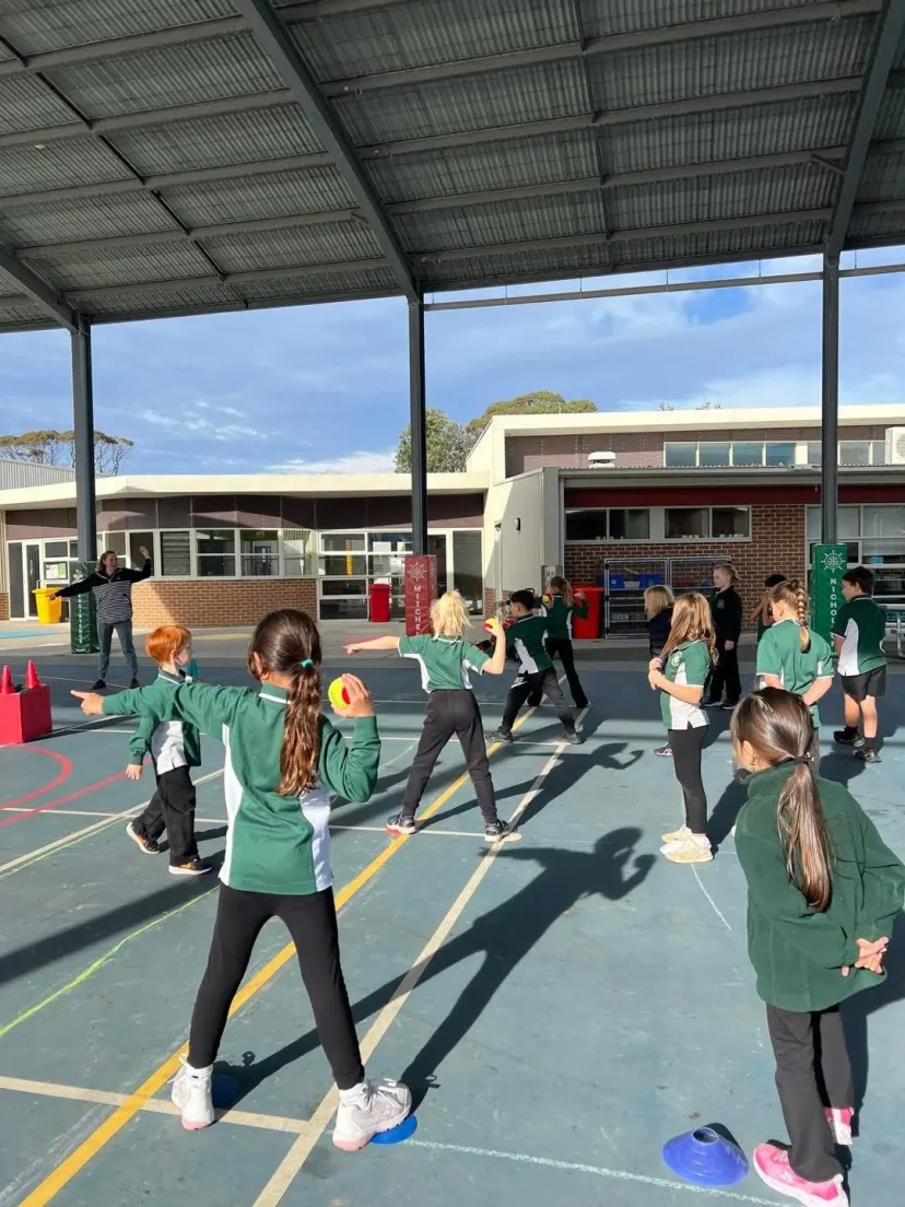 Students in a PE warm-up on the outdoor court